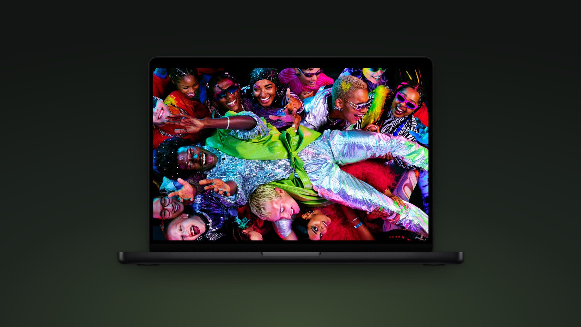 Apple MacBook Pro on a dark green gradient background
