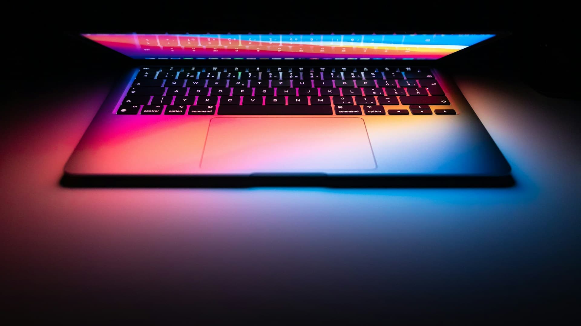 MacBook illuminated in a dark setting