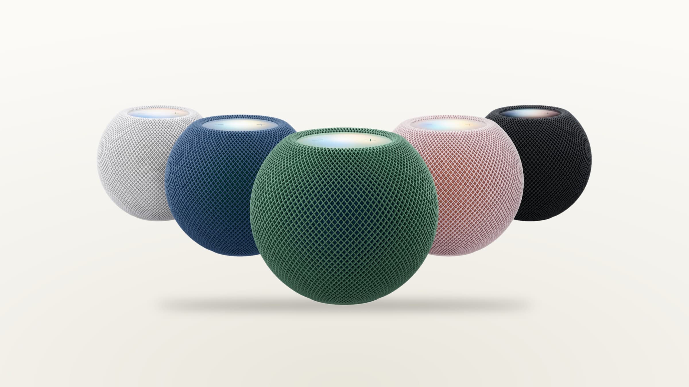 HomePod mini 2 speakers in white, blue, green, pink and midnight on a light gradient