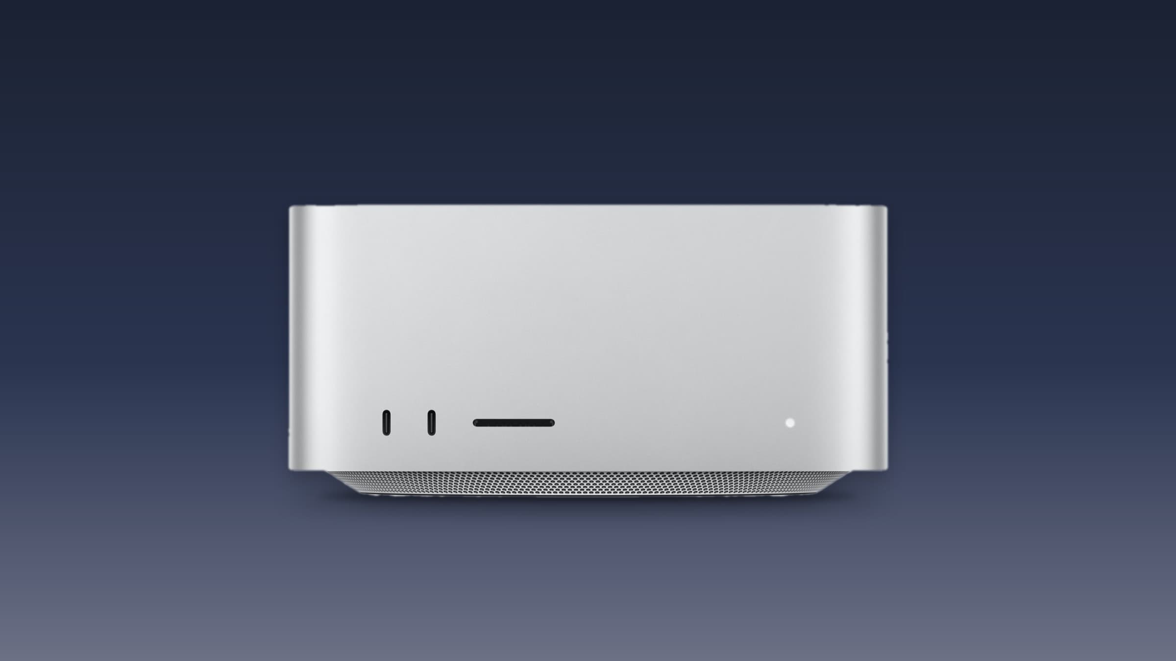 Silver Mac Studio seen from the front on a dark blue gradient background