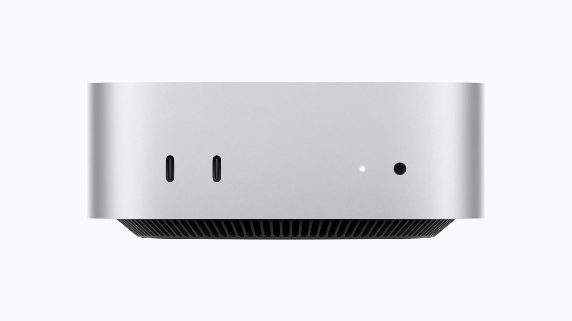 The new Mac mini in silver, showing its front USB-C ports and headphone jack