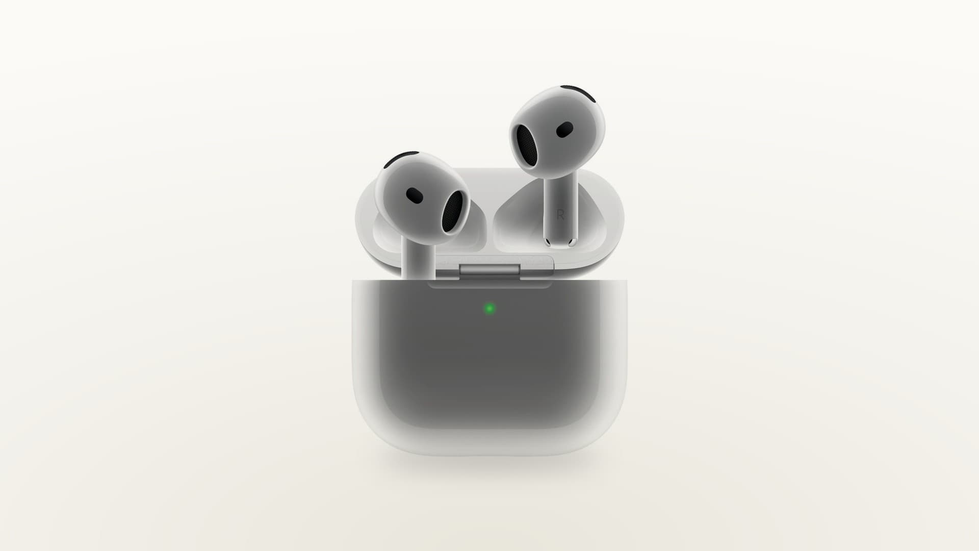 White AirPods and charging case on a light cream gradient background