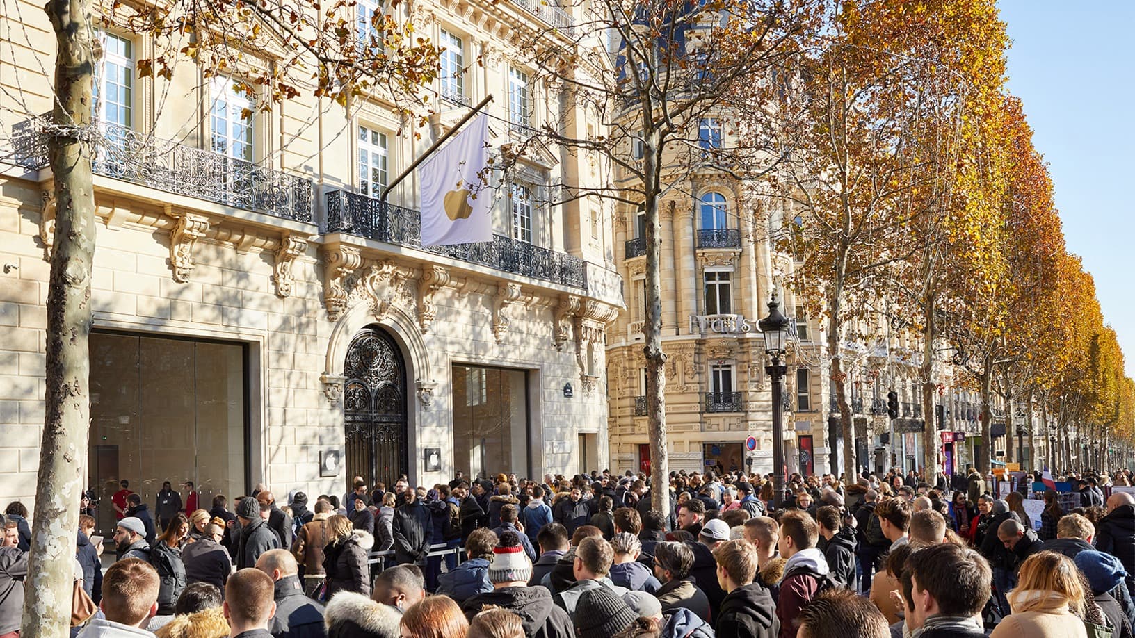 Exterior of the Apple Champs-Élysées store in Paris, with an Apple flag on its stone facade, pictured at the store's 2018 opening