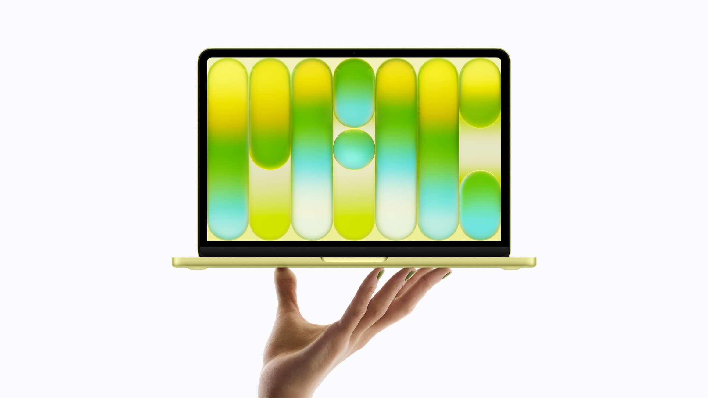 A hand holding up an open Citrus MacBook Neo against a white background