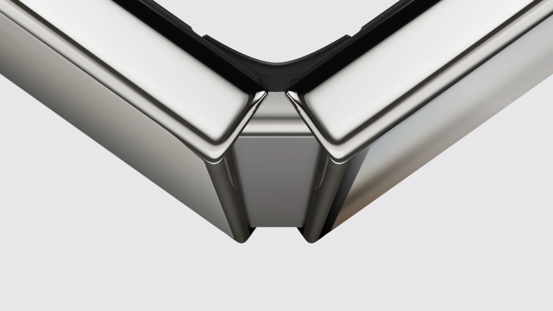 Close-up of the iPhone Duo's hinge, where Apple routes a flexible graphite pipe to carry heat between the two halves