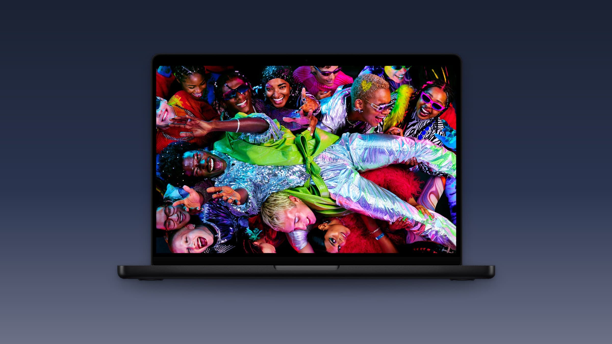 Space black MacBook Pro, open with a colourful image on screen, on a dark blue gradient background
